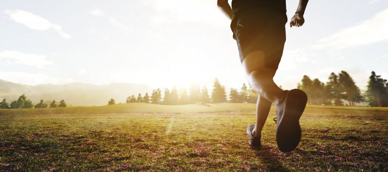 panoramic - man running marathon through the field