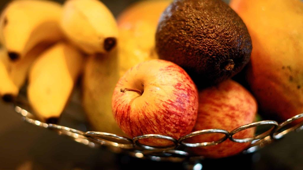 red apple fruit beside yellow banana fruit