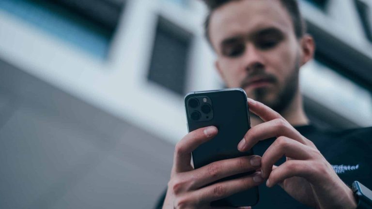 young men holding iPhone 11 Pro