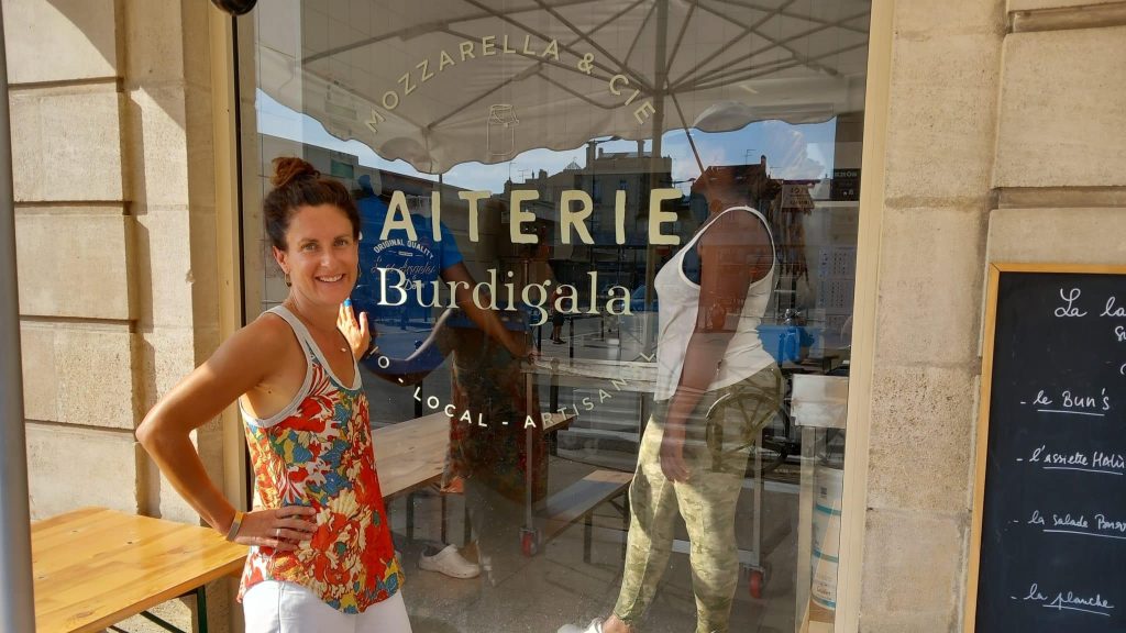 Claire Bouyssou pose devant la devanture de la laiterie Burdigala