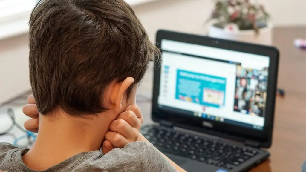 Kindergarten boy looking at laptop computer during first day of virtual learning online school.