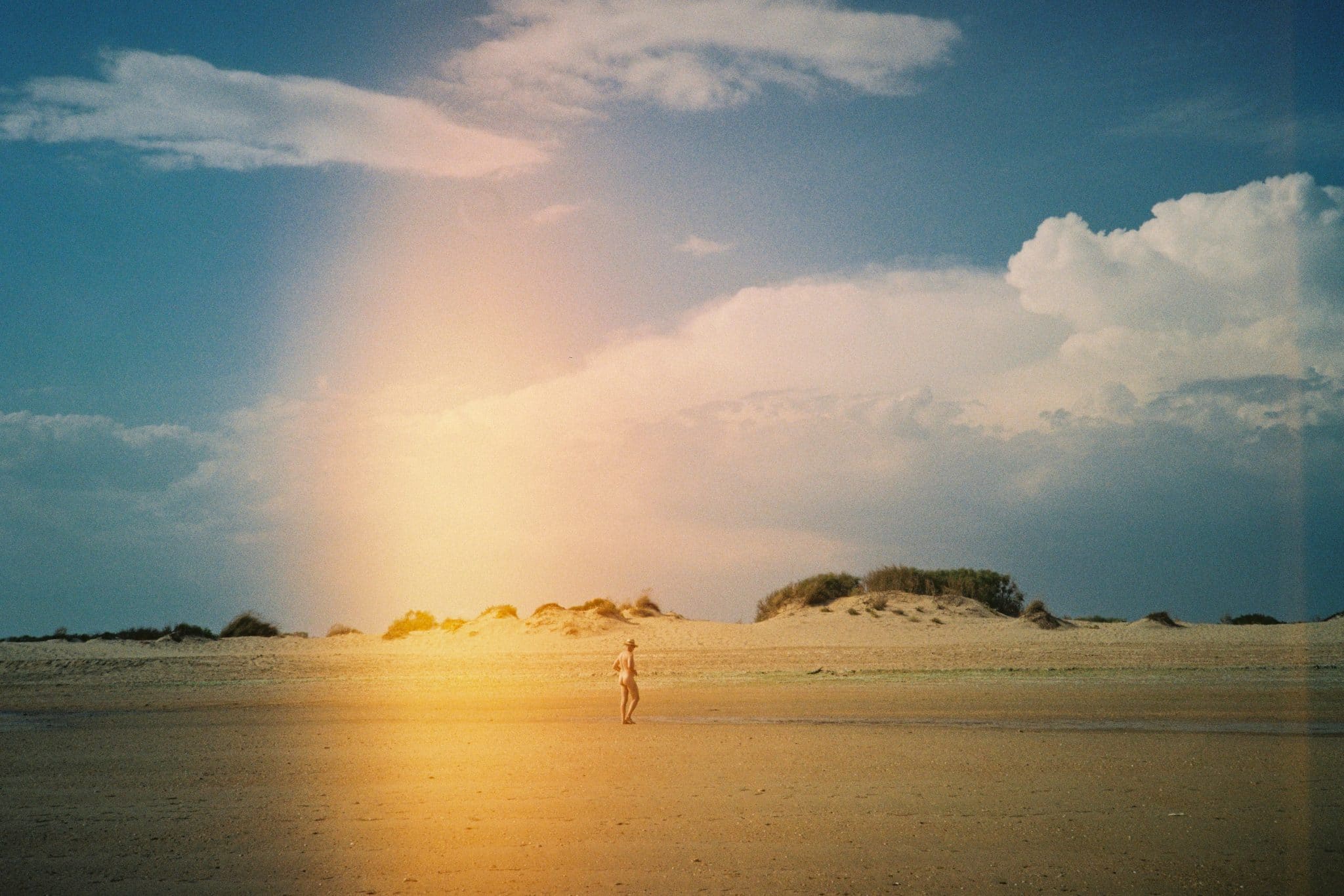 a person walking on a sandy beach