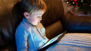 jeune enfant utilisant une tablette ordinateur à la maison
